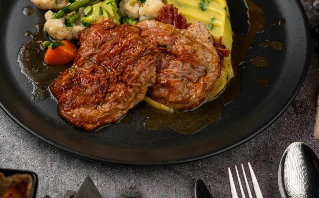 Savor a gourmet steak dinner with mashed potatoes and vegetables, ideal for food enthusiasts.